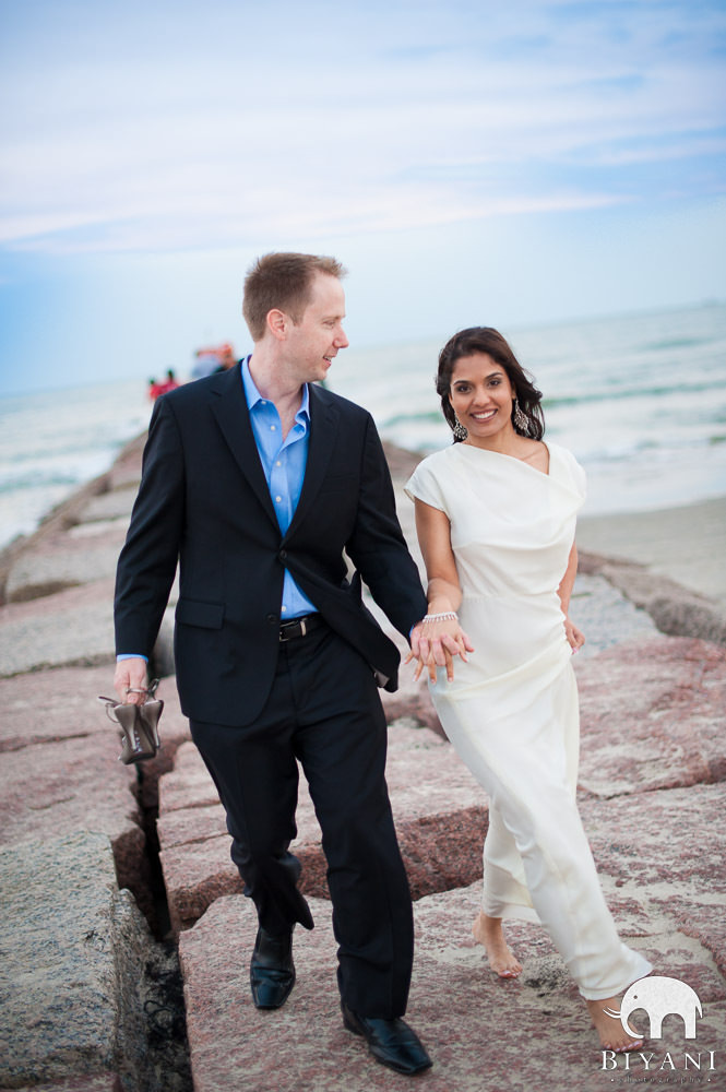 Engaged Indian couple walking on pier