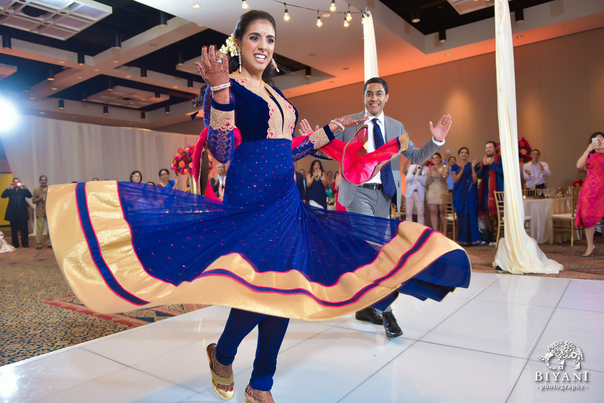 Indian bride twirling dress at reception