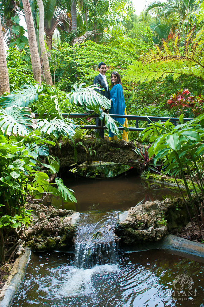 Indian Engagement Photography by waterfall and bride at Sunken Gardens in St. Petersburg Florida