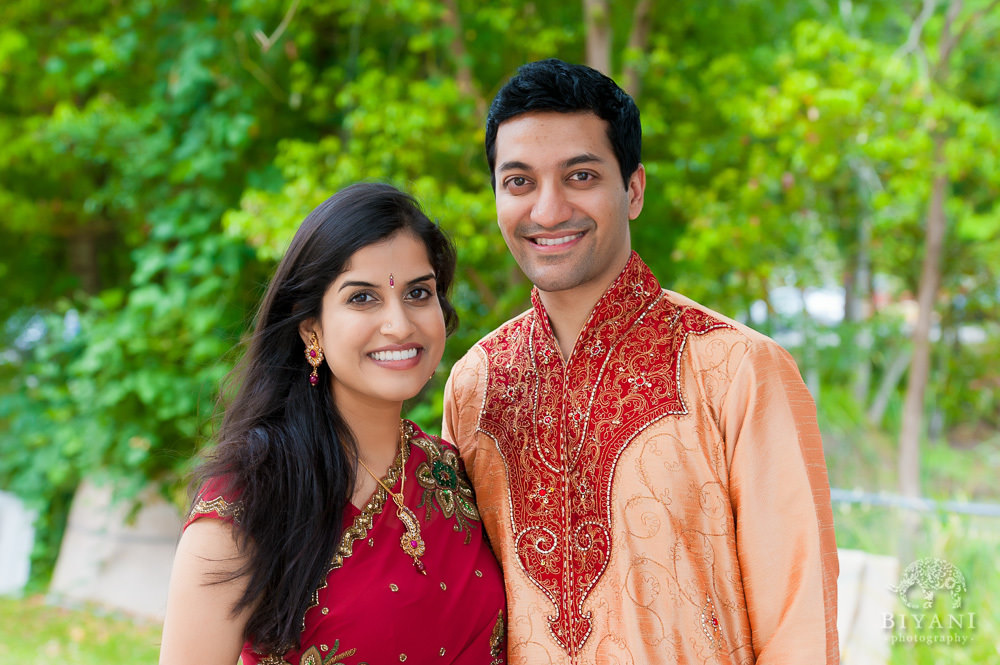 Indian Couple posing for their Engagement photos at the gardens out the Hindu Temple of Florida in Tampa, Florida during their Indian Engagement photos