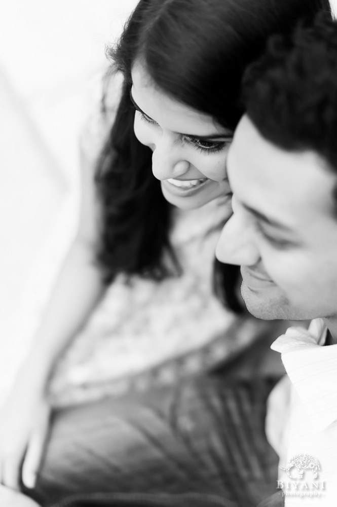 Black and White photo of Indian couple smiling during their Indian Engagement Photography session outside the Dali Museum in Tampa, Florida