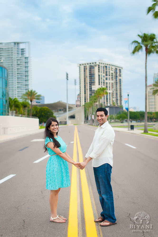 Indian couple holding hands in the middle of the road in Tampa Bay, Florida - right outside the Dali Museum