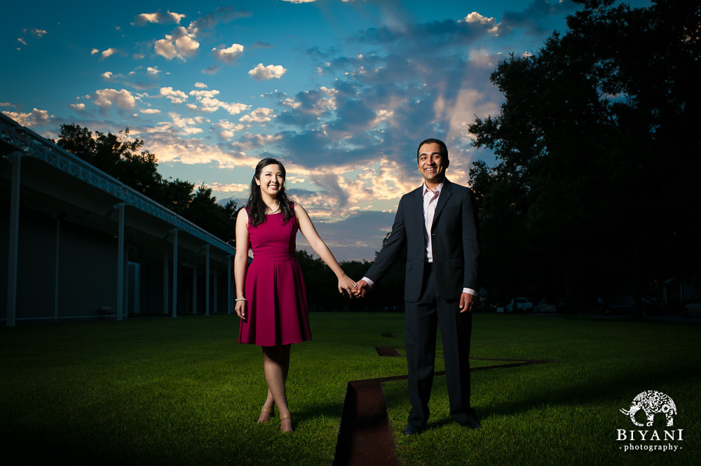 Couple holding hands outside Menil Collection Houston at sunset and posing for their engagement photos