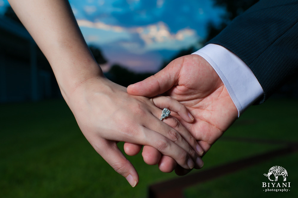 Engaged Couple holding hands and showing off the Engagement Ring