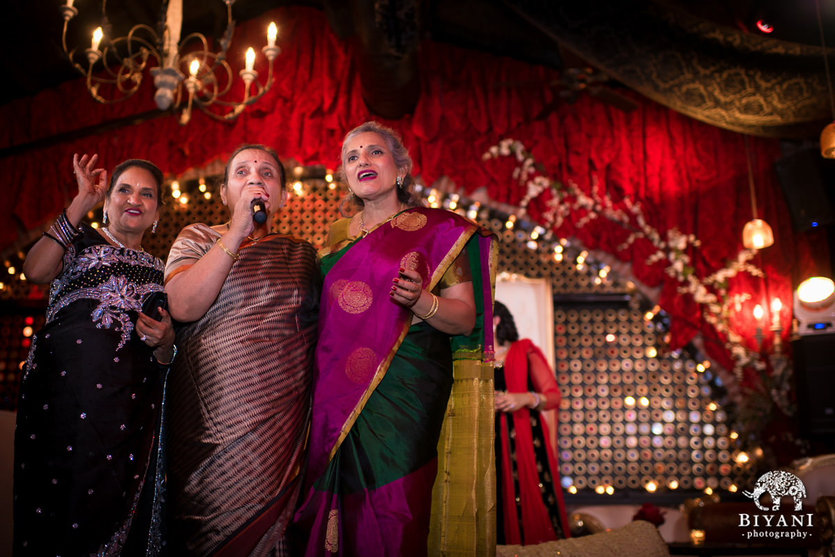 Moms singing for the couple at the Sangeet