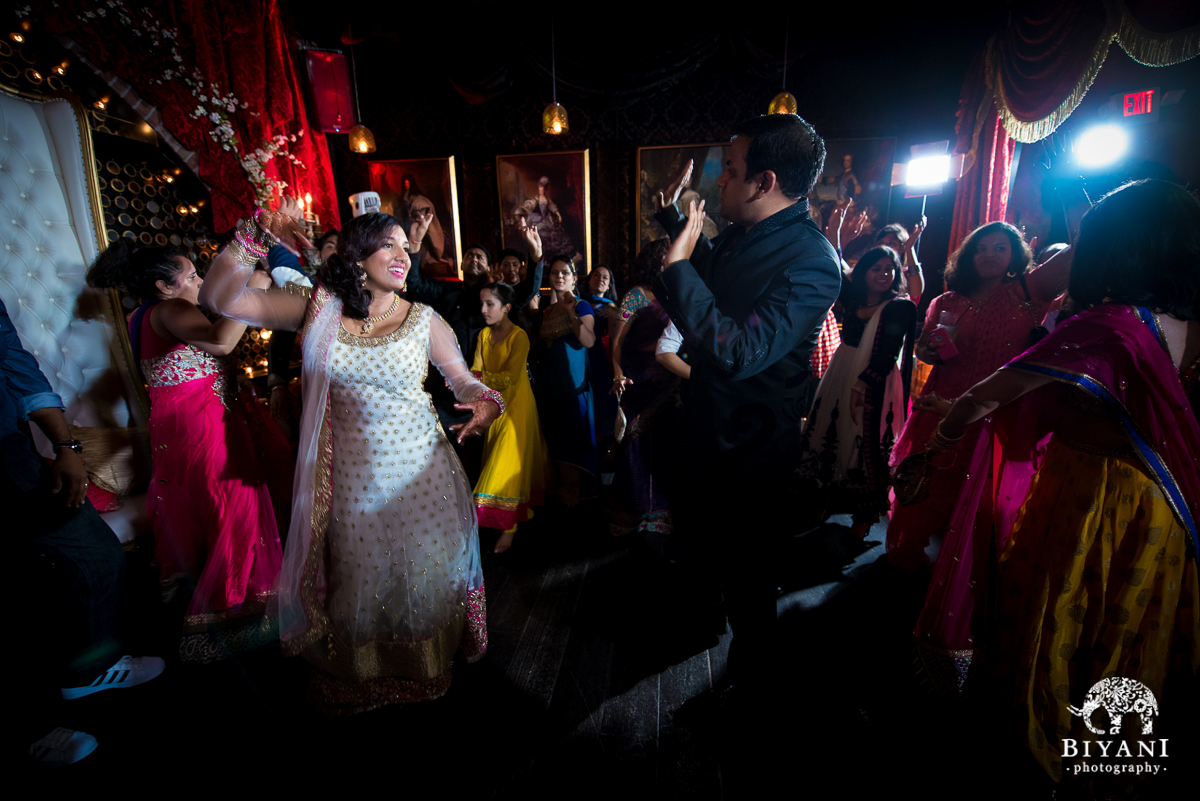 bride and groom dancing during sangeet