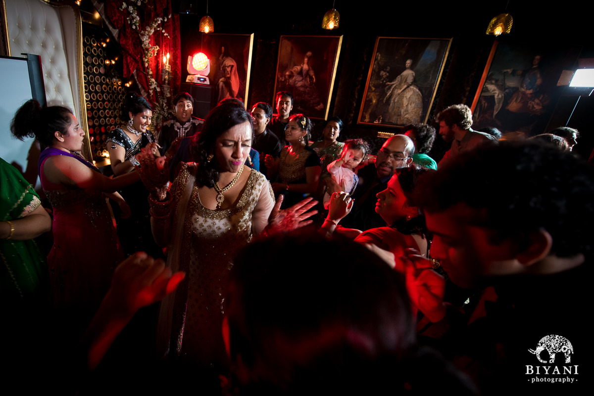 bride dancing with friends and family at sangeet