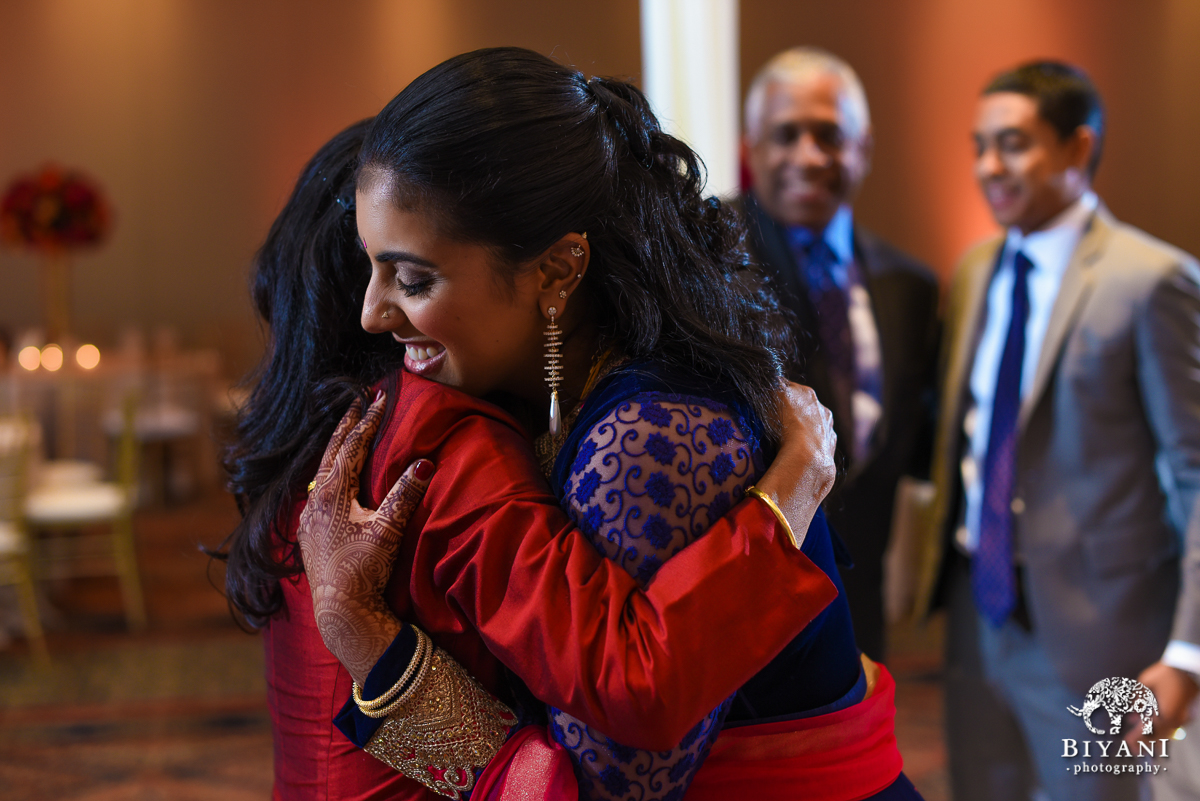 Indian bride hugging mother in law