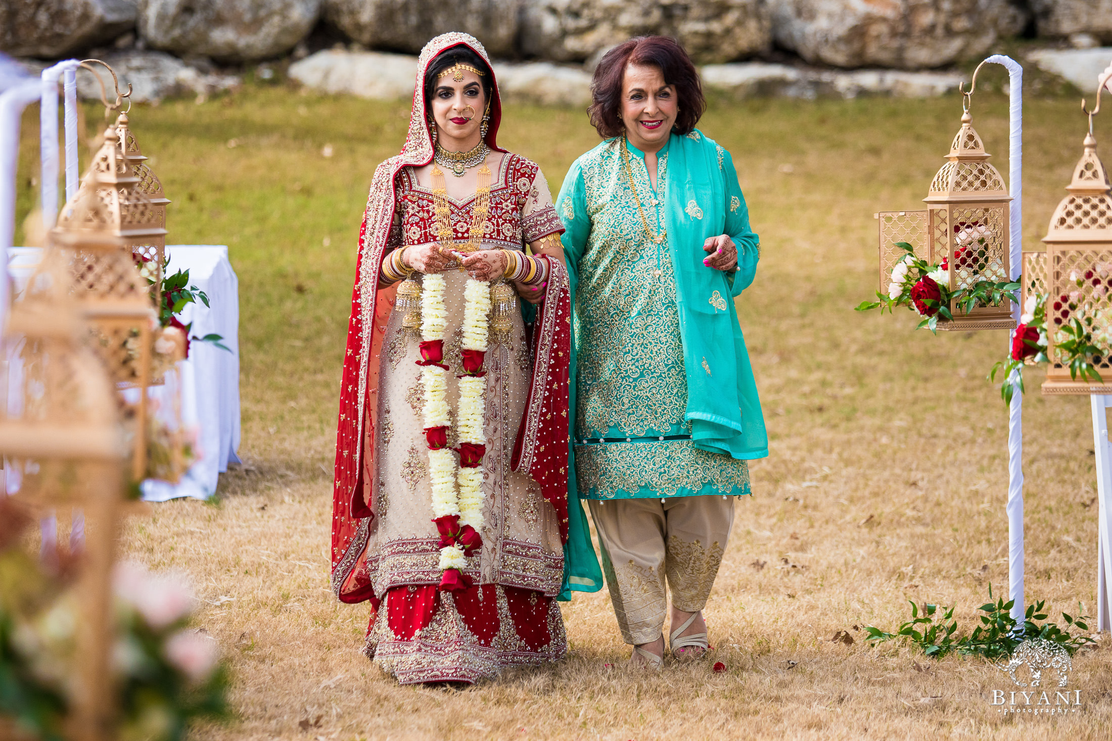 Indian Fusion Bride and her mother walking down the aisle during Indian wedding ceremony outdoors