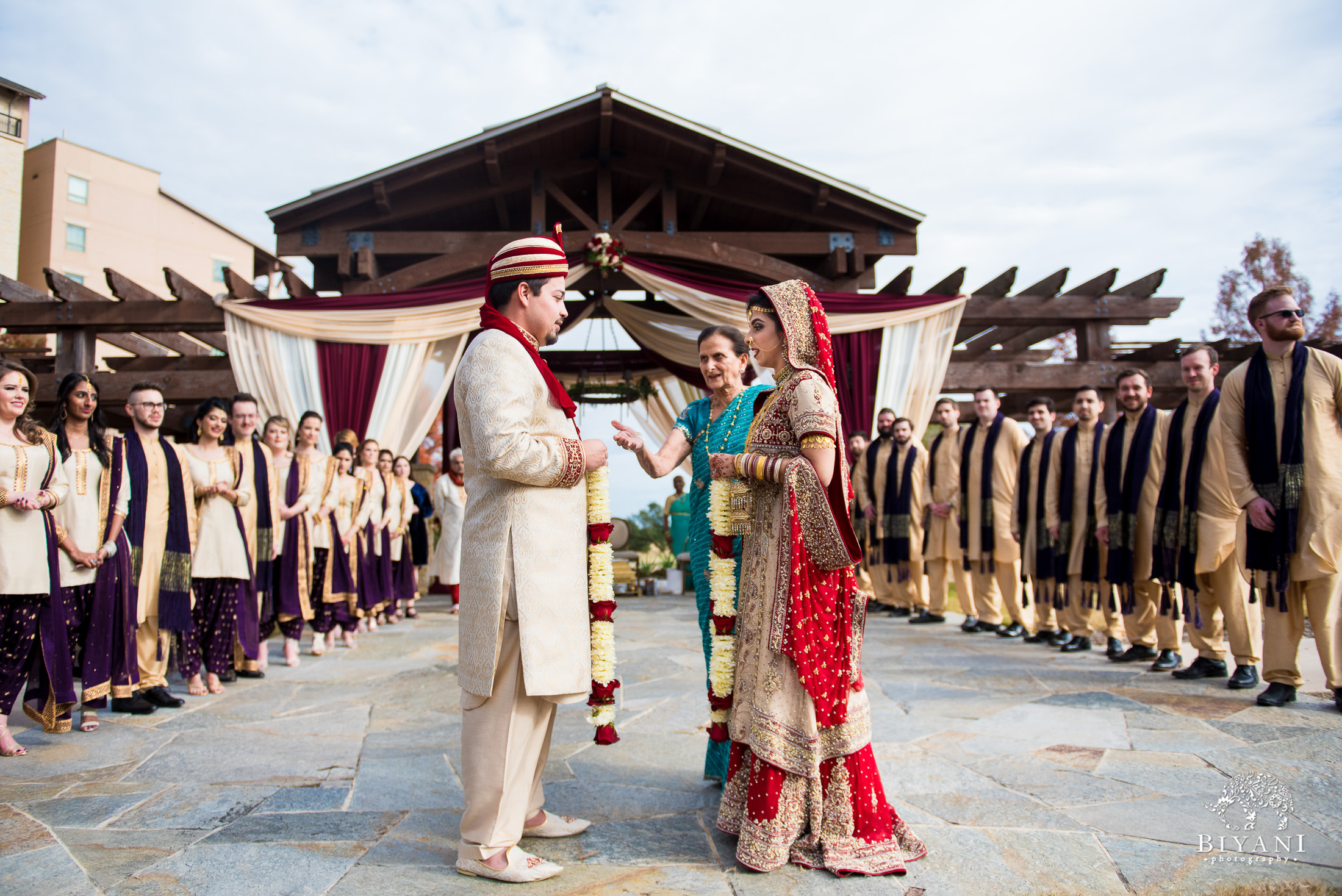 Indian Fusion bride and groom during Indian wedding ceremony outdoors