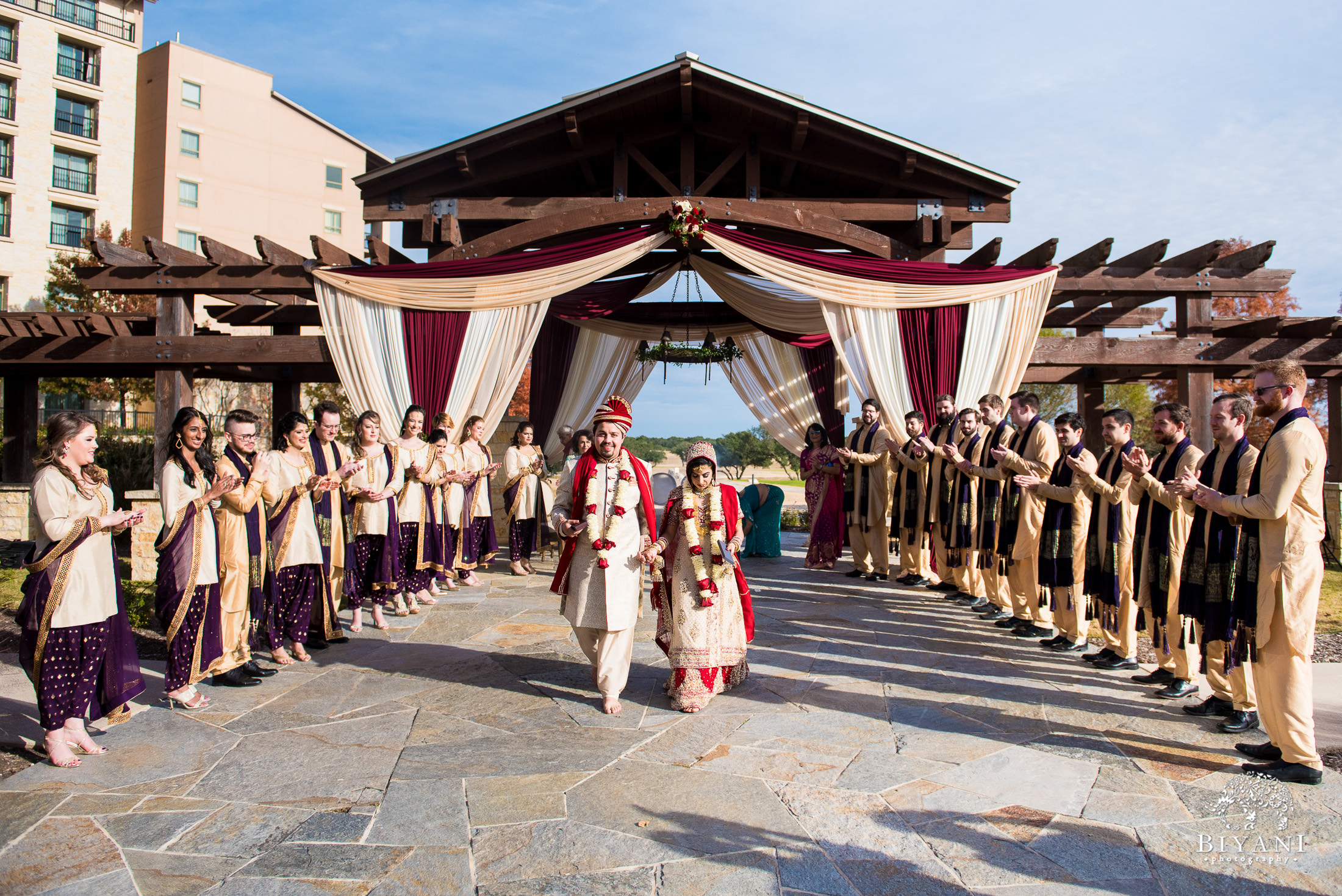 Indian Fusion bride and groom walking down the aisle together after Indian wedding ceremony 