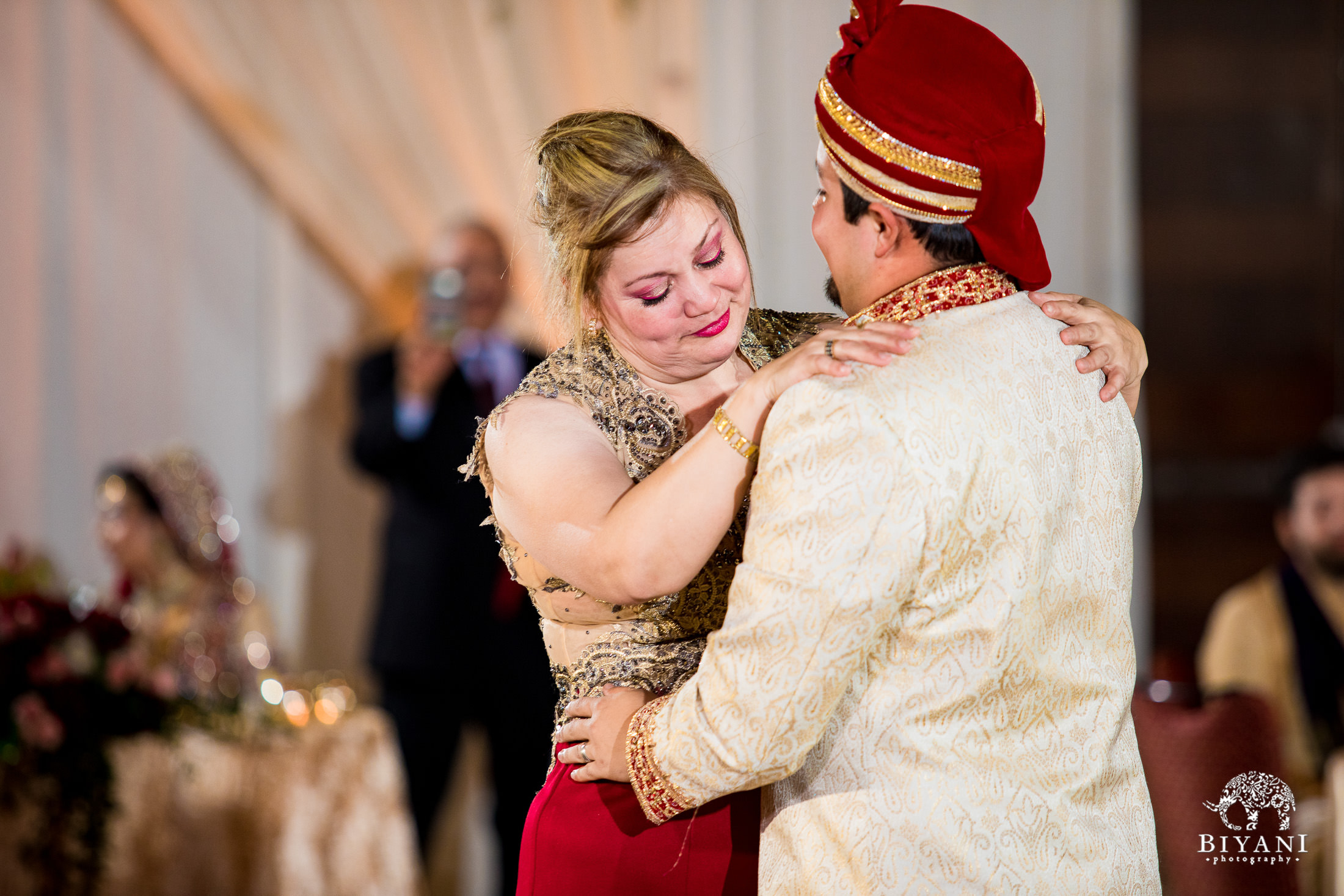 Groom and mother dance at reception party 