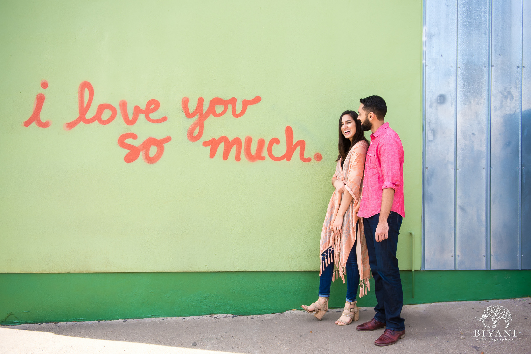 Engaged Couple outside I love you so much sign at Jo's Coffee on South Congress in Austin, TX