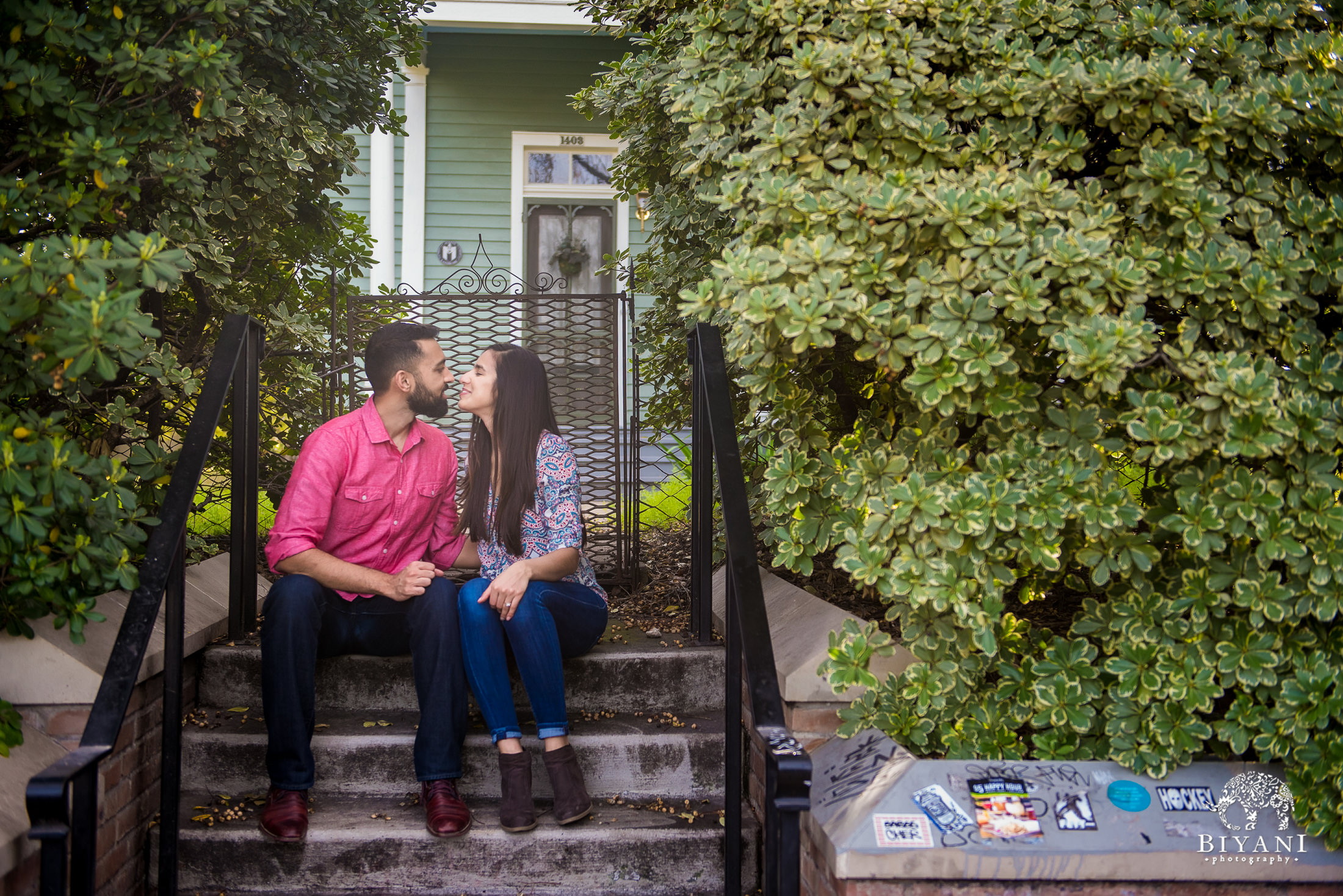 Indian couple sitting on steps posing for an engagement photo shoot in south Congress Austin, TX