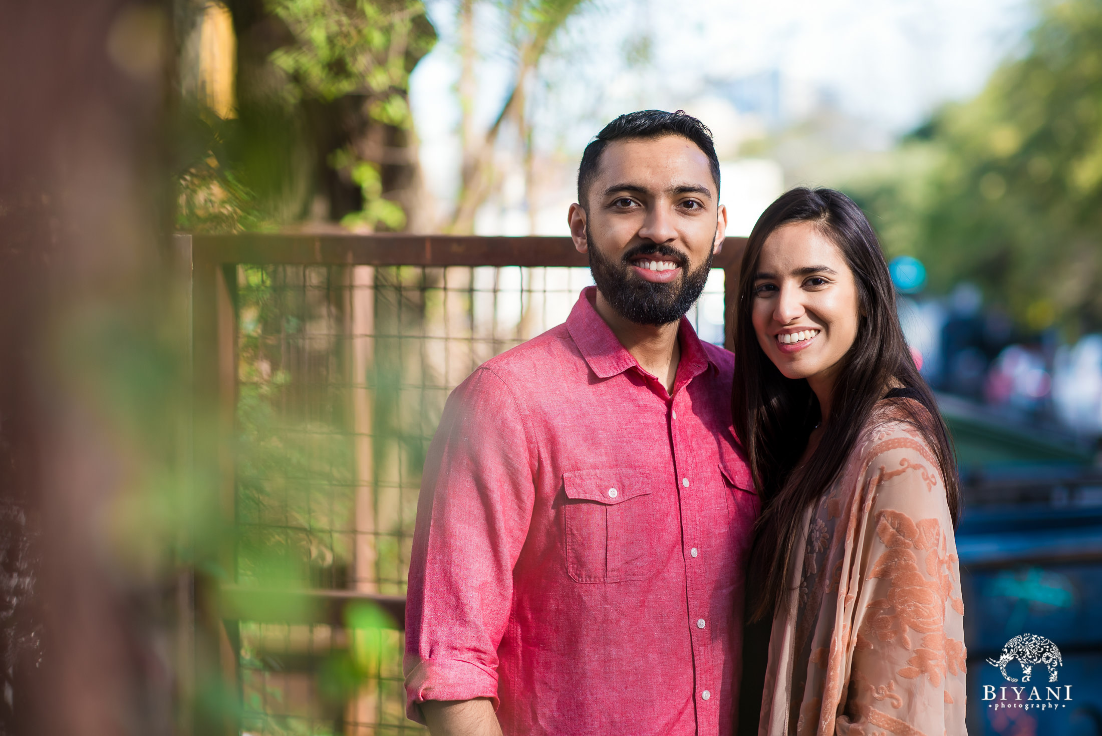 An Indian couple posing on the streets of South Congress Austin, TX for their engagement photo shoot