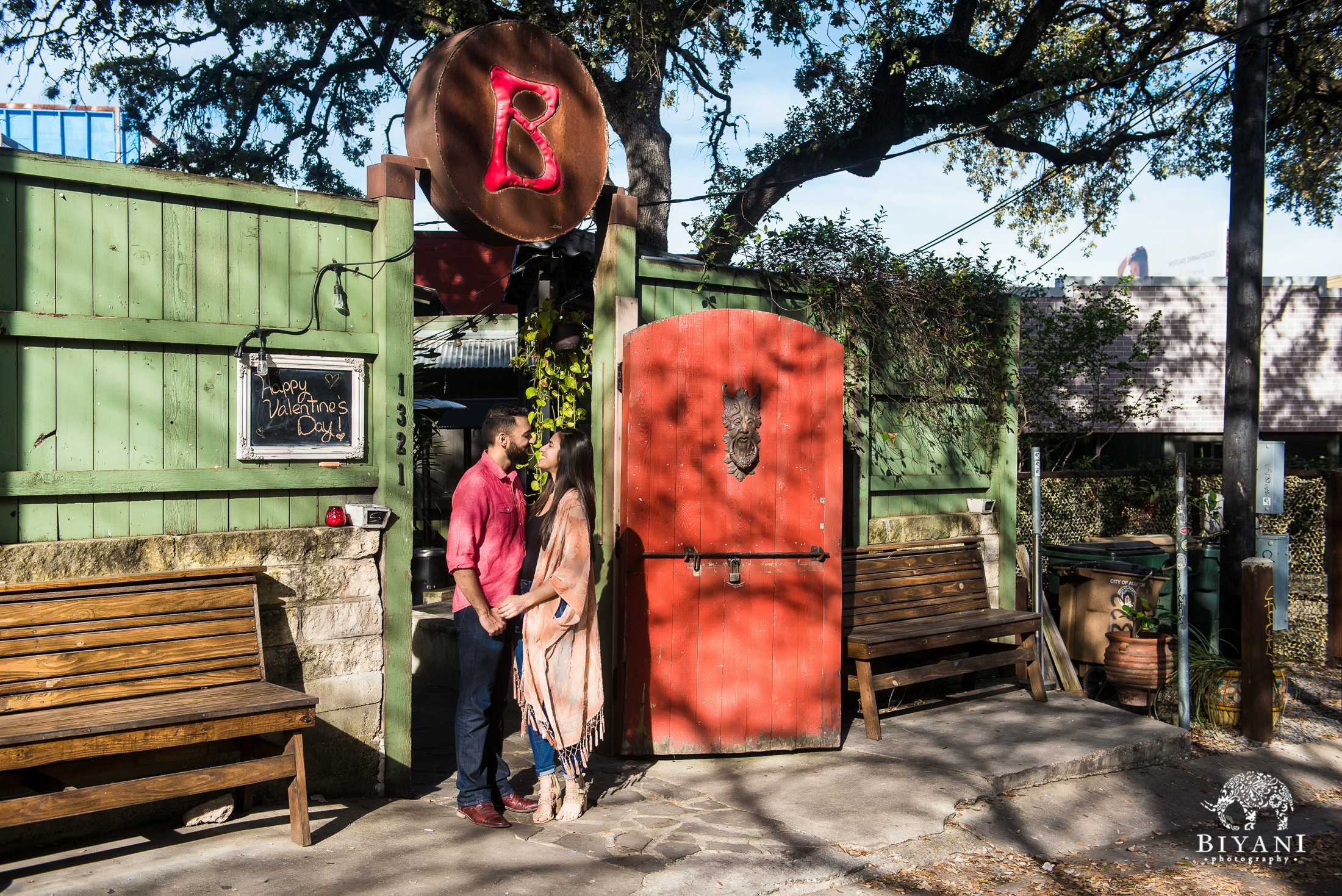 Indian couple standing in front of a restaurant for their engagement photo shoot in South Congress Austin, Tx.