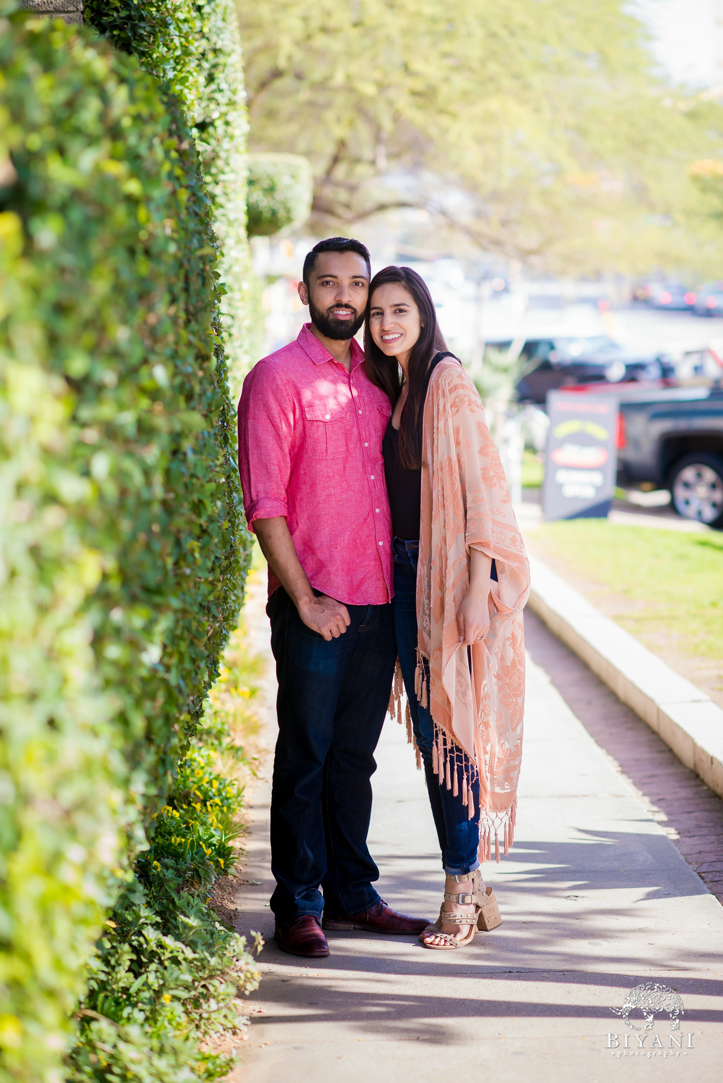 An Indian couple posing on the streets of South Congress Austin, TX for their engagement photo shoot