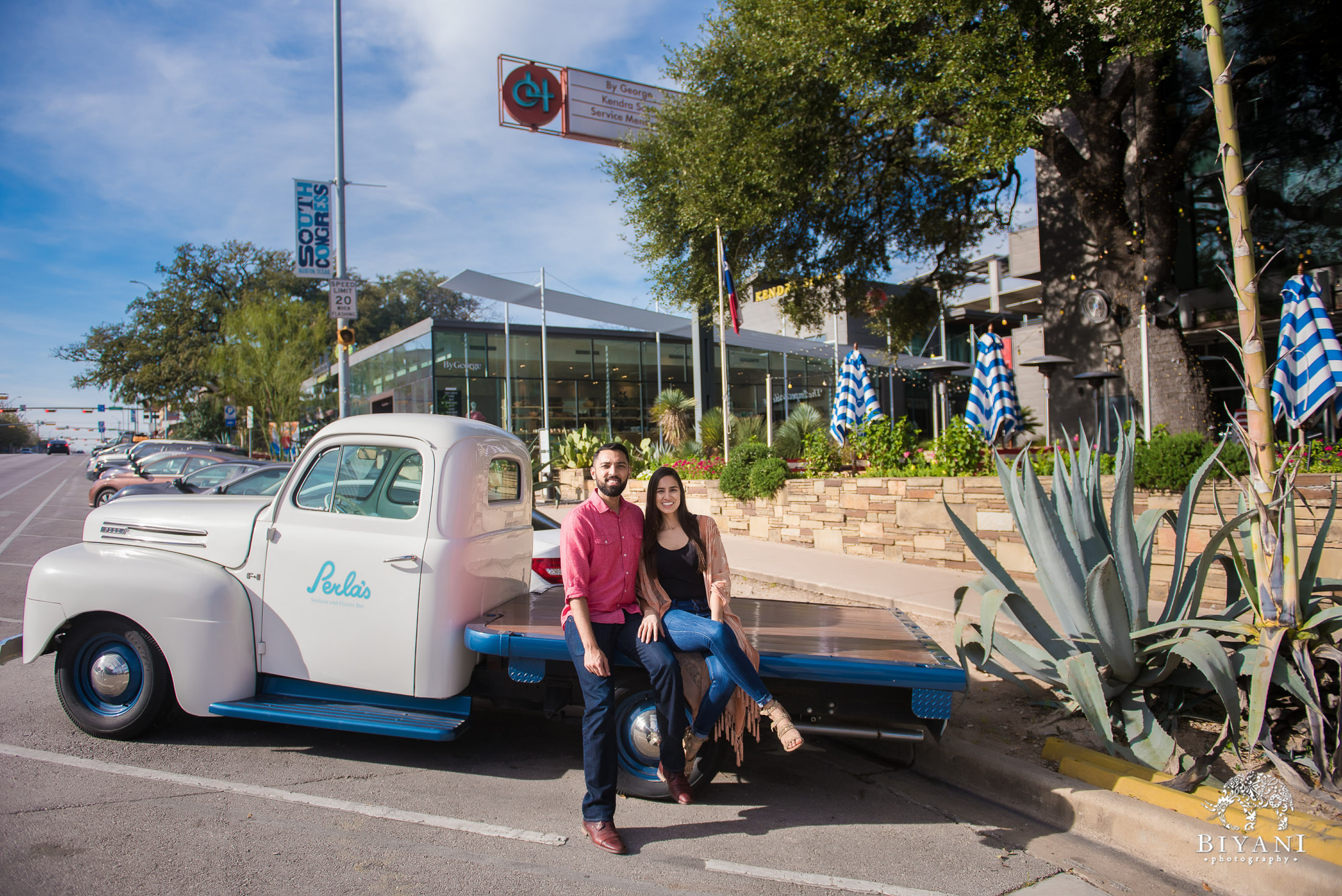 Indian couple sitting on a Perla's truck bed in Austin, Tx. during their engagement photo shoot