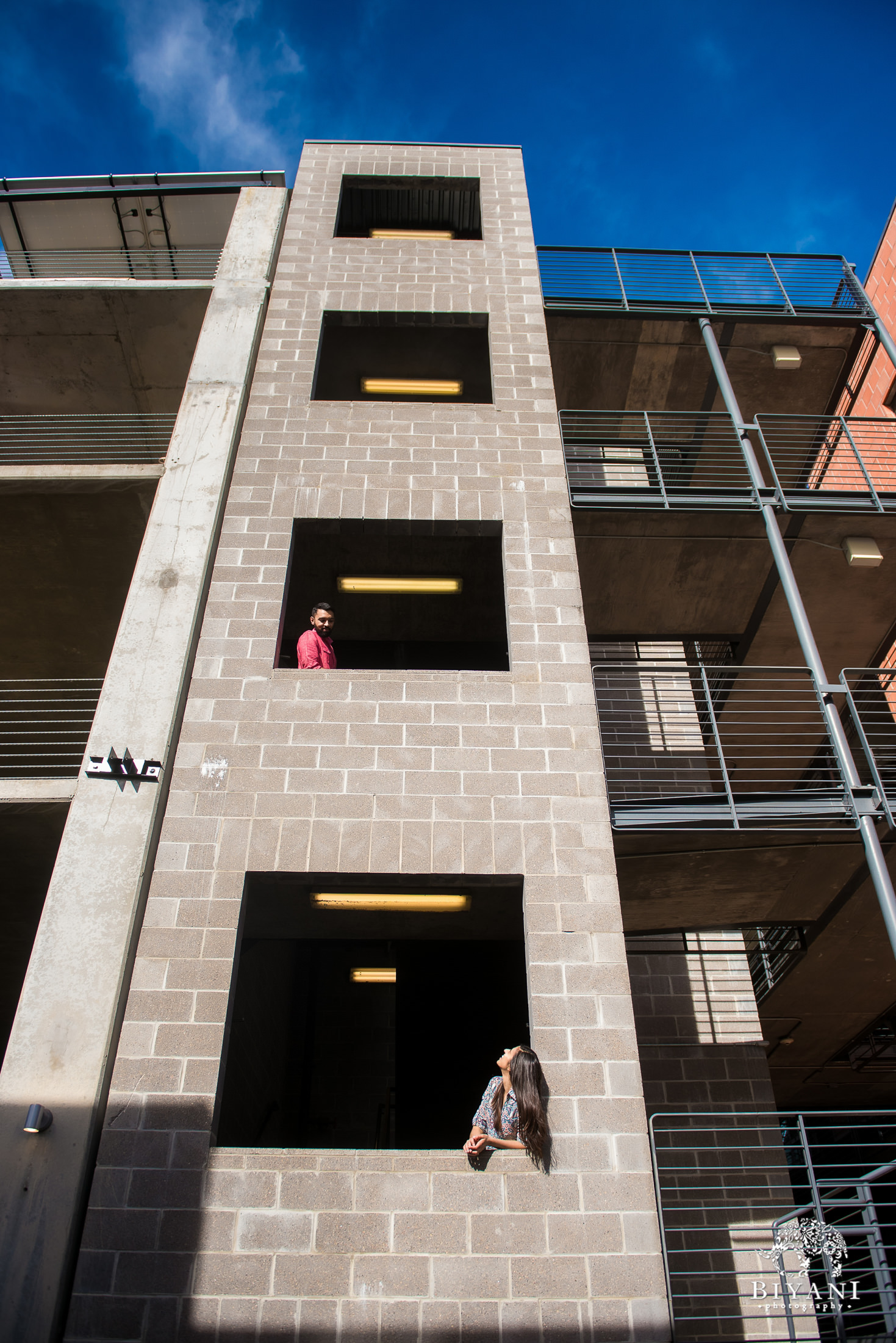 Indian couple taking silly photos in a parking garage in Austin, Tx. during their engagement photo shoot