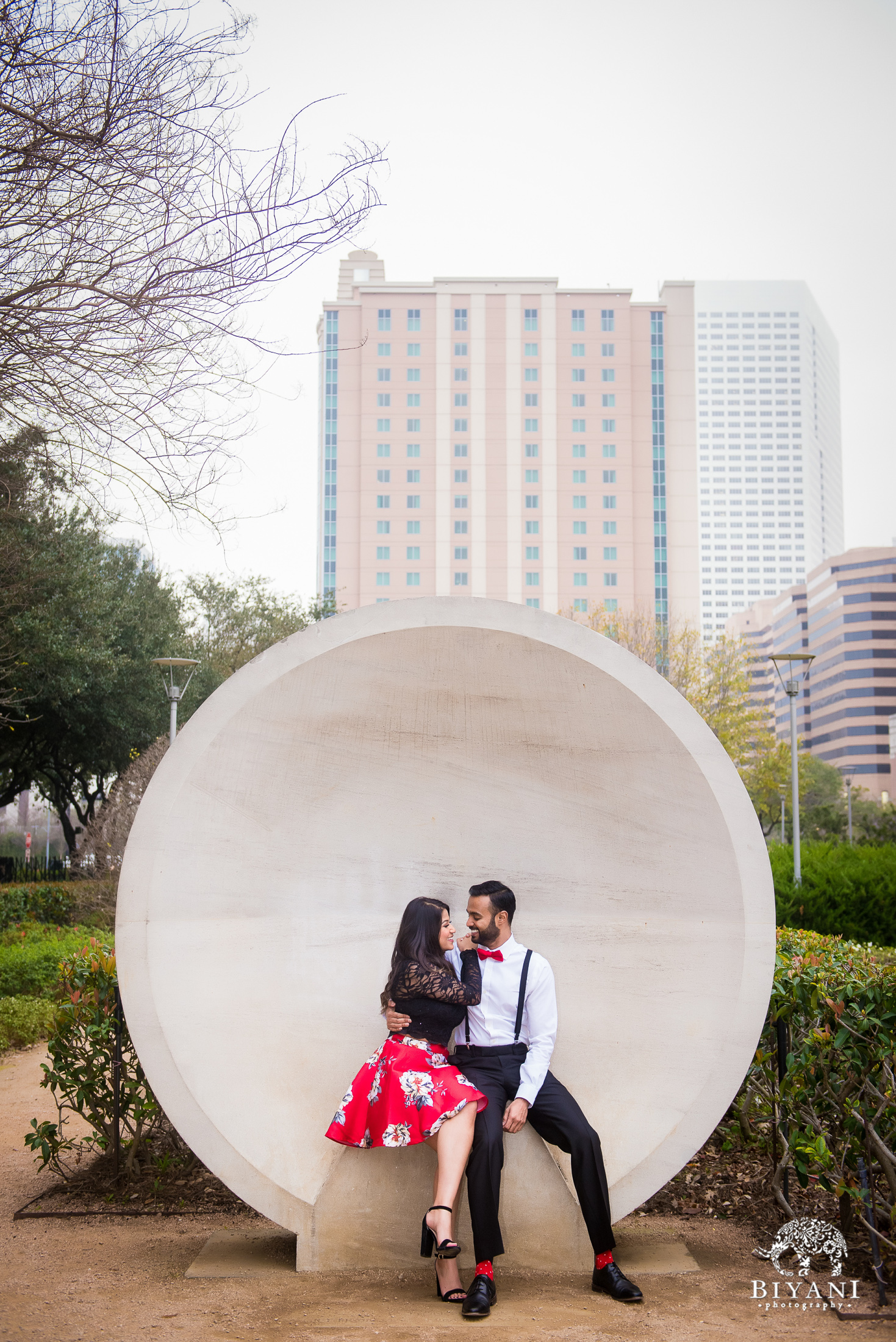 couple poses at the Listening Vessels in Houston, Tx. Discovery Green Park