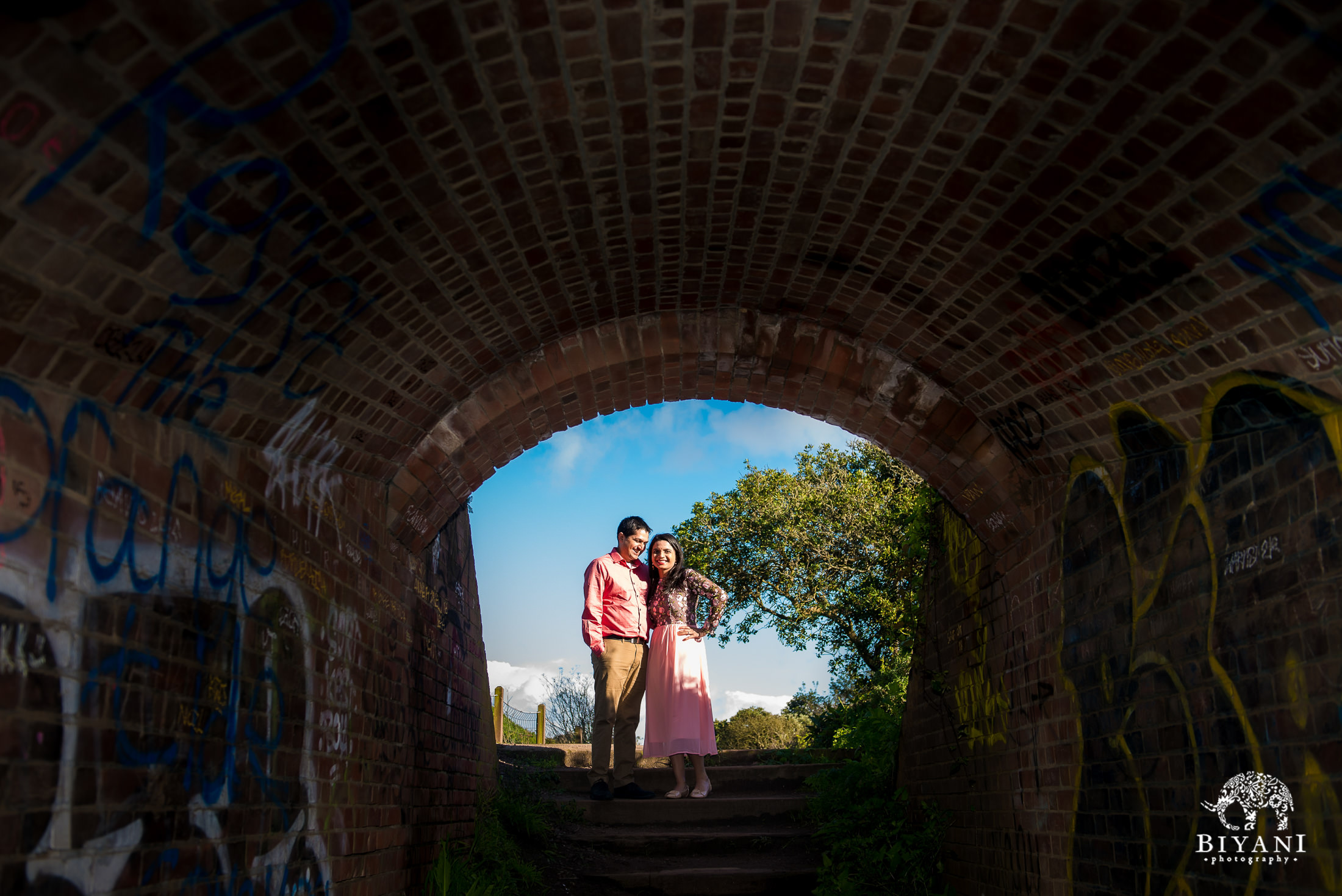 couple posing in a tunnel entrance in San Francisco for engagement photo shoot