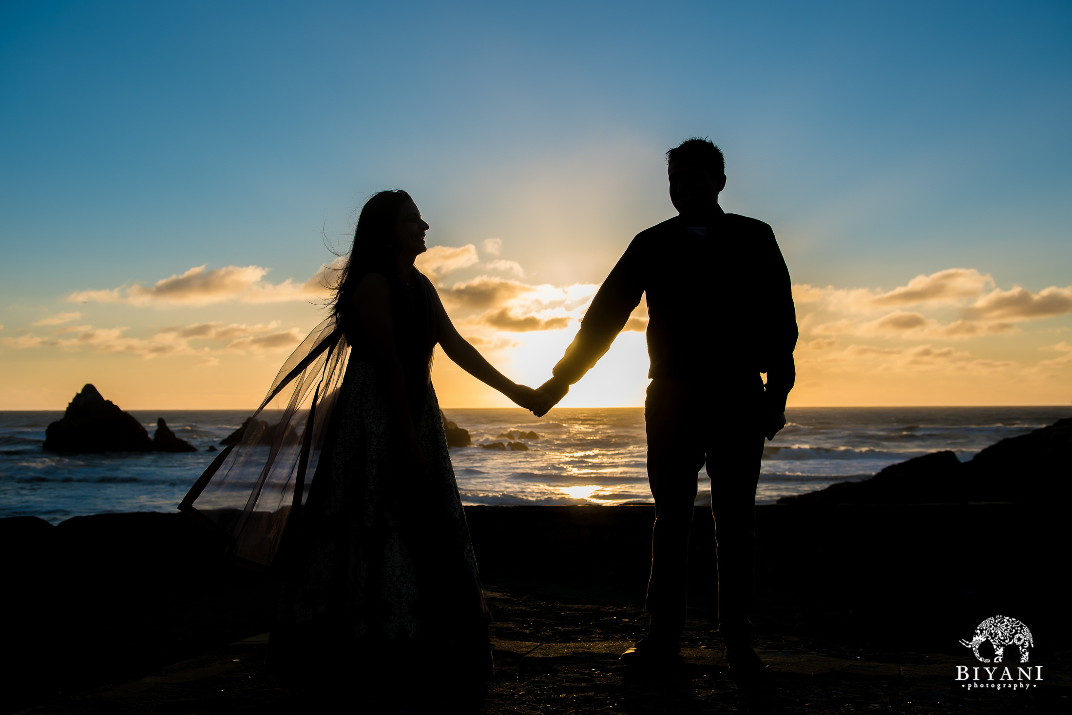 silhouette of couple during sunset on the beach in San Francisco engagement photo shoot