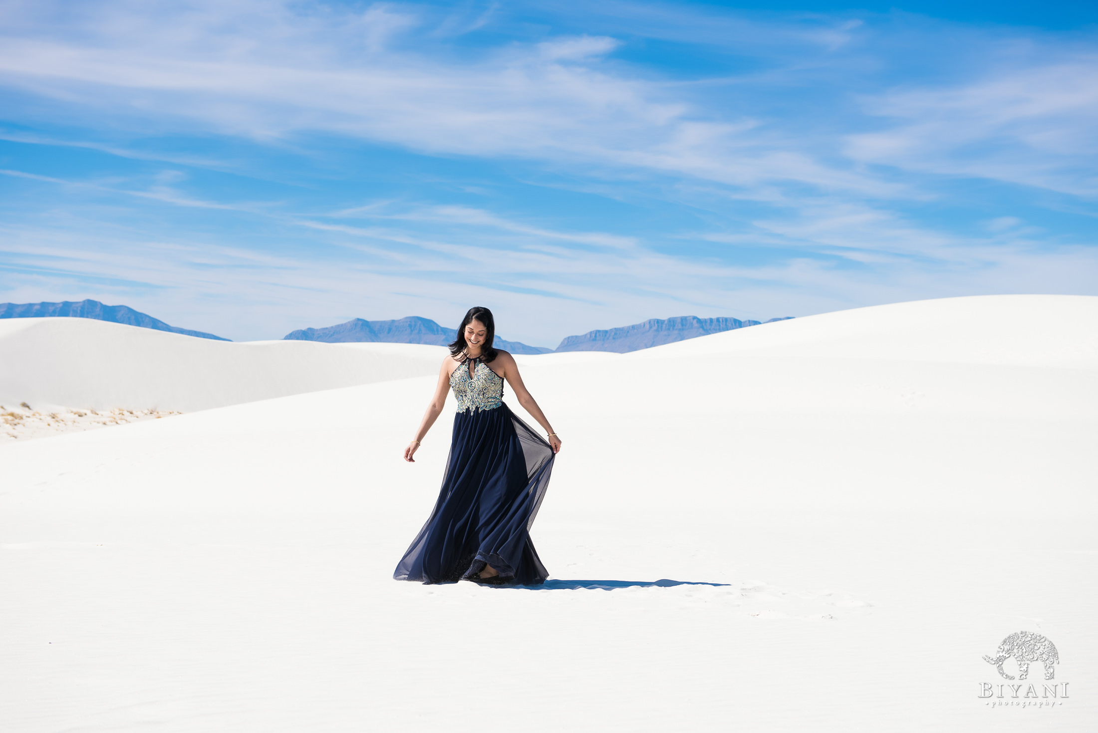 bride to be twirls around in the white sand