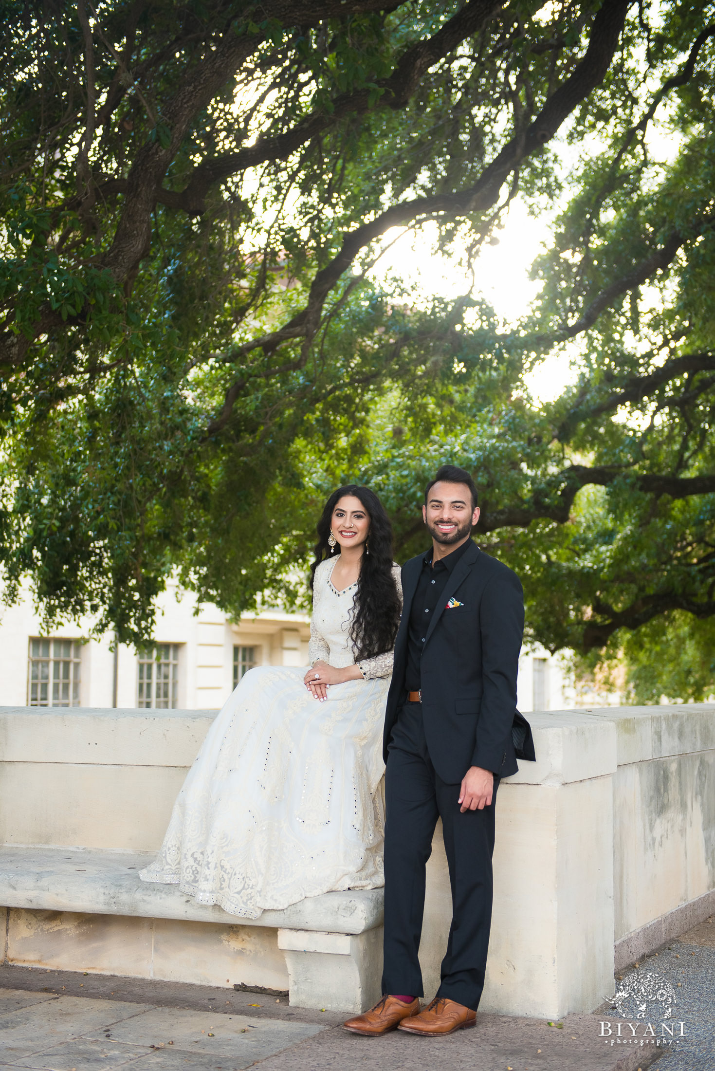 couple sitting on ledge at University of Texas Austin campus