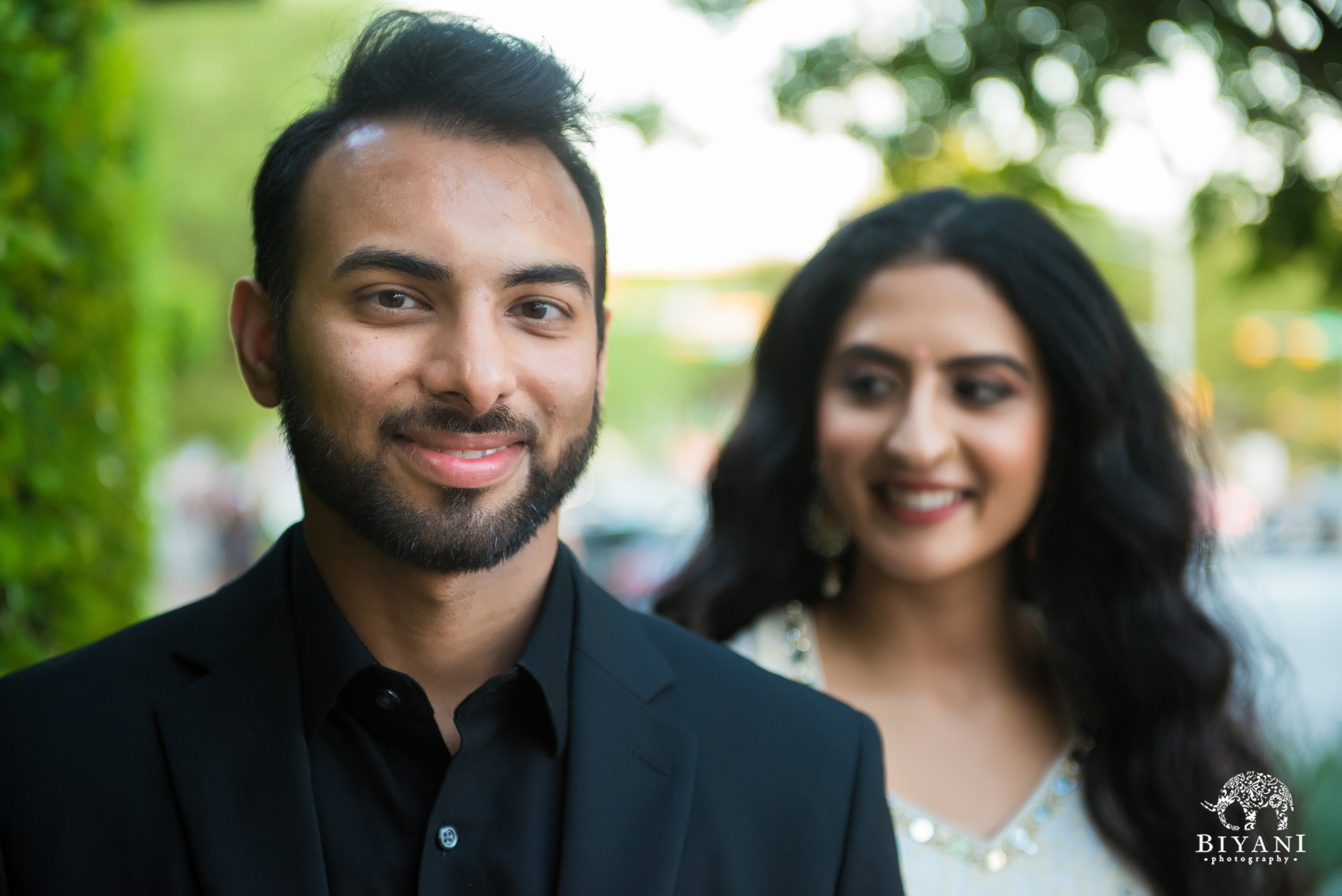 bride and groom posing on the streets of Austin, Texas during Indian Engagement photo shoot